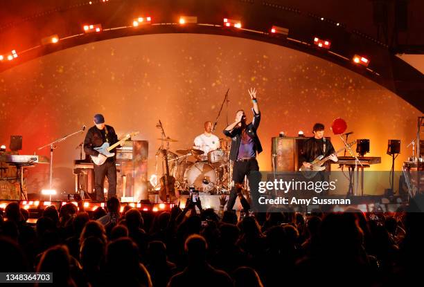 Jonny Buckland, Will Champion, Chris Martin, and Guy Berryman of Coldplay performs onstage during the 8th annual "We Can Survive" concert hosted by...