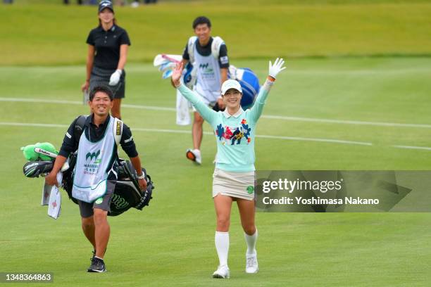 Ha-neul Kim of South Korea waves as she spots on her friend and fellow golfer Bo-mee Lee in the gellery as she plays her final hole of her...