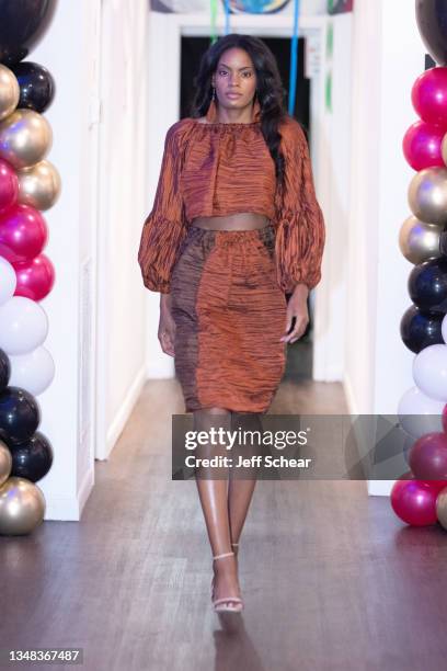 Model walks the runway during the GY6 Showcase at FTM Fashion Week Season 9 at the Jacksonville Onslow Council for the Arts on October 23, 2021 in...