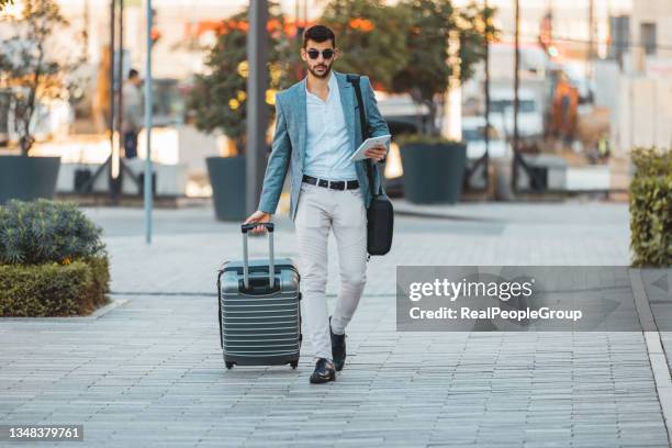 businessman  walking with suitcase in the street. - travel real people stockfoto's en -beelden