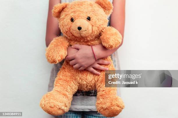 mid section of a little girl holding her teddy bear - moroccan girls bildbanksfoton och bilder