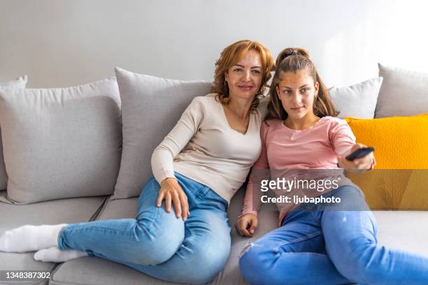 mother and daughter relaxing at home watching tv - friends tv show stock pictures, royalty-free photos & images