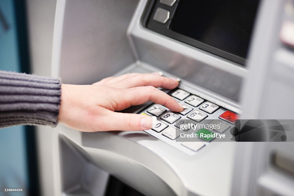 Woman using ATM