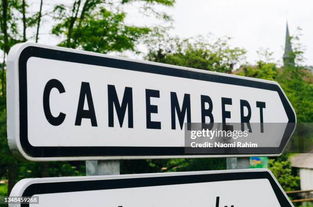 camembert street sign, in orne, normandy, france - camembert stock-fotos und bilder