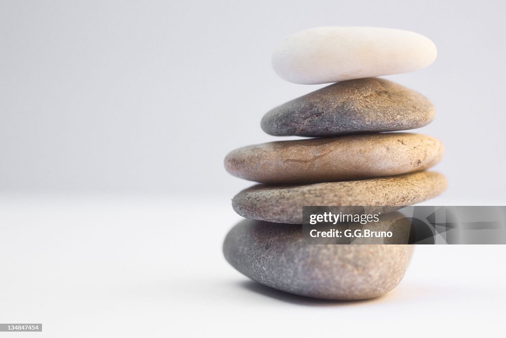 Stack of pebbles on white background