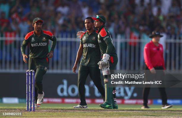 Mohammad Saifuddin of Bangladesh celebrates the wicket of Wanindu Hasaranga of Sri Lanka with team mate Nurul Hasan during the ICC Men's T20 World...