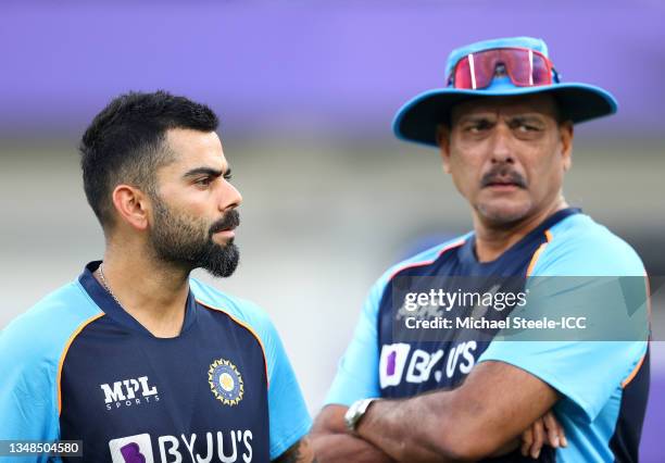 Virat Kohli of India looks on alongside Ravi Shastri, Head Coach of India during the ICC Men's T20 World Cup match between India and Pakistan at...