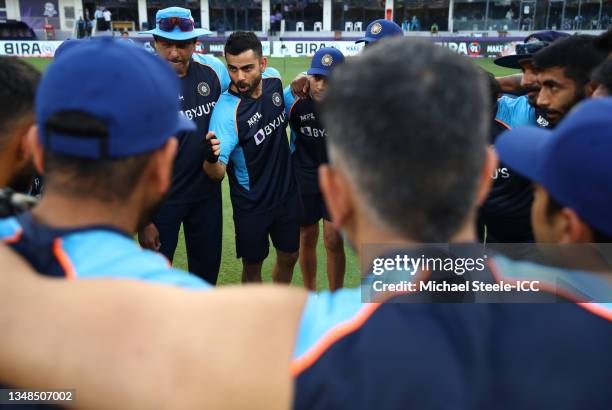 Virat Kohli of India looks on alongside Ravi Shastri, Head Coach of India during a team huddle ahead of the ICC Men's T20 World Cup match between...