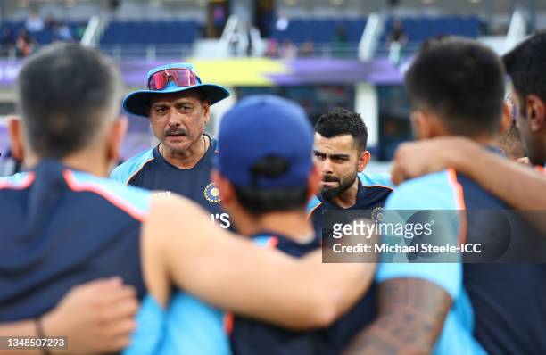 Virat Kohli of India looks on alongside Ravi Shastri, Head Coach of India during a team huddle ahead of the ICC Men's T20 World Cup match between...