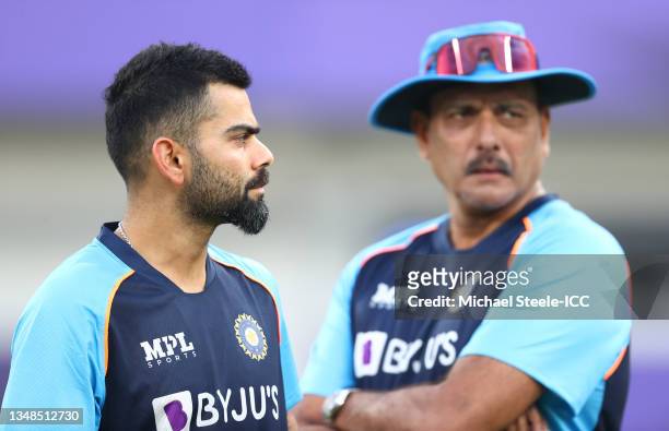 Virat Kohli of India looks on alongside Ravi Shastri, Head Coach of India during the ICC Men's T20 World Cup match between India and Pakistan at...