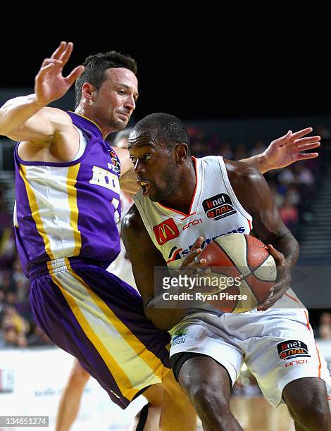 Jamar Wilson of the Taipans pushes past Aaron Bruce of the Kings during the round nine NBL match between the Sydney Kings and the Cairns Taipans at...