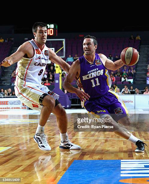 Aaron Bruce of the Kings pushes past Brad Hill of the Taipansduring the round nine NBL match between the Sydney Kings and the Cairns Taipans at...