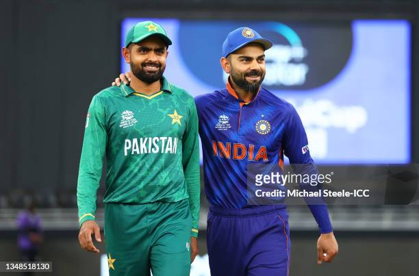 Babar Azam of Pakistan and Virat Kohli of India interact ahead of the ICC Men's T20 World Cup match between India and Pakistan at Dubai International...
