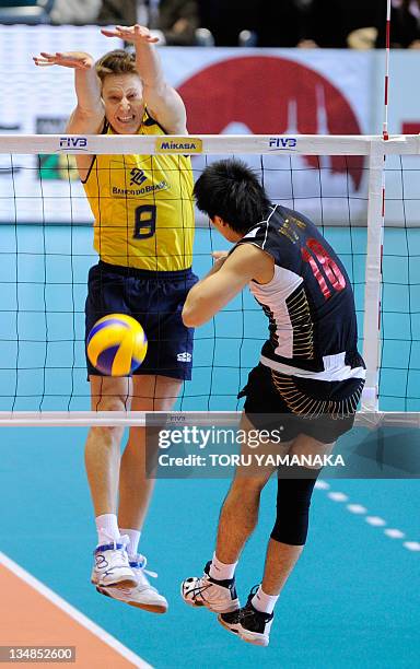 Murilo Endres of Brazil blocks a spike from Yuta Yoneyama of Japan during their match of the World Cup men's volleyball tournament in Tokyo on...