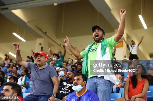 Fans of Pakistan celebrate the wicket of Rohit Sharma of India during the ICC Men's T20 World Cup match between India and Pakistan at Dubai...