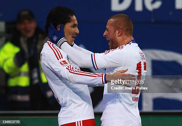 Paolo Guerrero of Hamburg celebrates with his team mate Goekhan Toere after scoring his team's first goal during the Bundesliga match between...