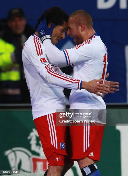 Paolo Guerrero of Hamburg celebrates with his team mate Goekhan Toere after scoring his team's first goal during the Bundesliga match between...