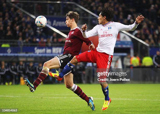 Paolo Guerrero of Hamburg and Christian Eigler of Nuernberg battle for the ball during the Bundesliga match between Hamburger SV and 1. FC Nuernberg...