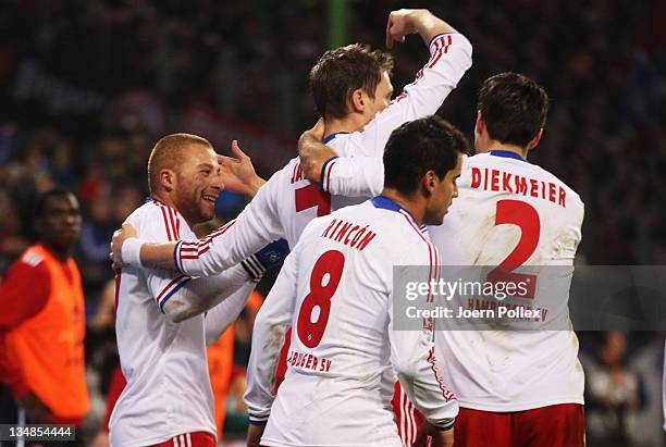 Marcell Jansen of Hamburg celebrates with his team mate Goekhan Toere after scoring his team's second goal during the Bundesliga match between...