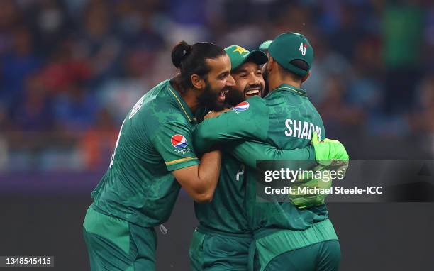 Mohammad Rizwan of Pakistan celebrates after taking a catch to dismiss Suryakumar Yadav of India with team mates Shadab Khan and Imad Wasim during...