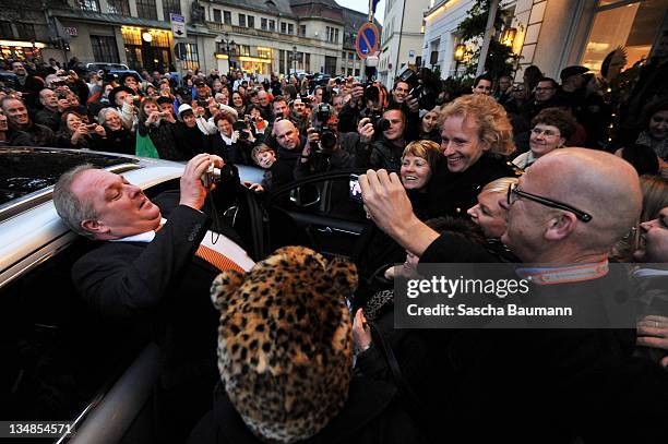 Thomas Gottschalk greets fans waiting for him to leave his hotel for the 199th "Wetten dass...?" show at the Rothaus Hall on December 3, 2011 in...