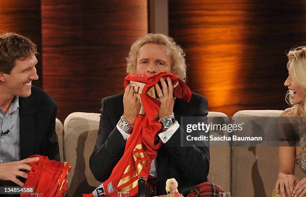 Thomas Gottschalk smells a shirt that Dirk Nowitzki brought as present during the 199th "Wetten dass...?" show at the Rothaus Hall on December 3,...