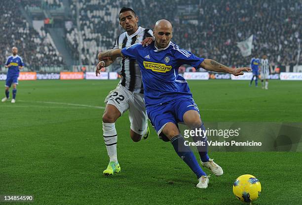 Arturo Vidal of Juventus FC challenges Guillermo Rodriguez of AC Cesena during the Serie A match between Juventus FC and AC Cesena at Juventus...