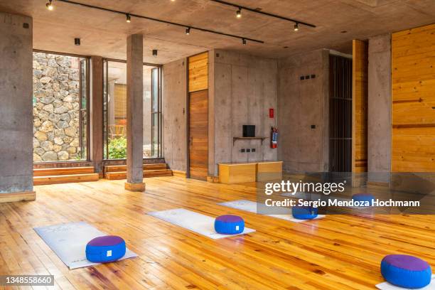 yoga studio with wood paneling, yoga exercise mats and yoga blocks in a boutique spa hotel resort in tepoztlan, mexico - vip room stock pictures, royalty-free photos & images