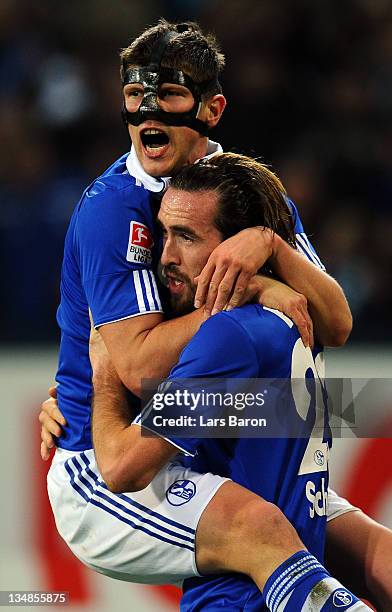 Christian Fuchs of Schalke celebrates with team mate Klaas Jan Huntelaar after scoring his teams second goal during the Bundesliga match between FC...