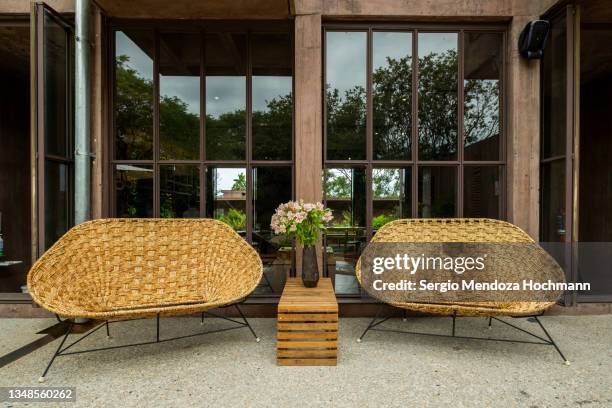 wicker chairs in front of the restaurant in a beautiful boutique spa resort in tepoztlan, mexico - cuernavaca stockfoto's en -beelden