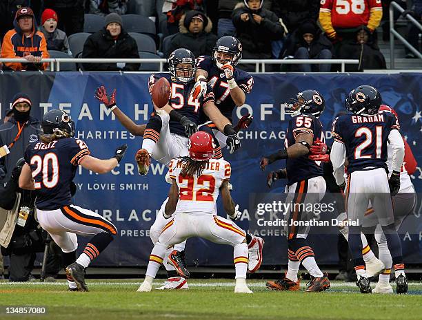 Brian Urlacher and Chris Conte of the Chicago Bears knock down a "Hail Mary" pass as Dexter McCluster of the Kansas City Chiefs waits to catch the...