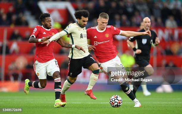 Mohamed Salah of Liverpool holds off Fred and Scott McTominay of Manchester United during the Premier League match between Manchester United and...