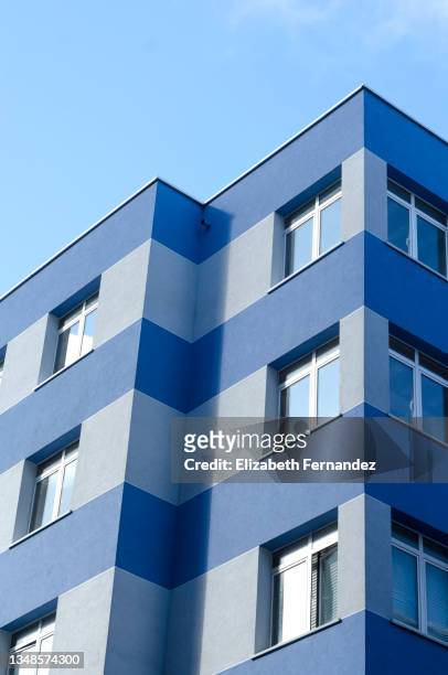 low angle view of residential buildings against blue sky - curtain wall facade stock pictures, royalty-free photos & images
