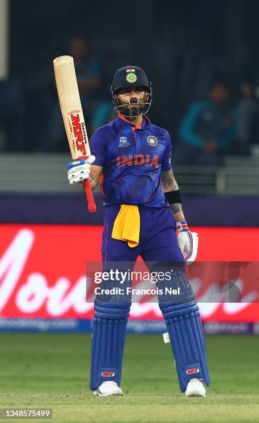 Virat Kohli of India celebrates their half century during the ICC Men's T20 World Cup match between India and Pakistan at Dubai International Stadium...
