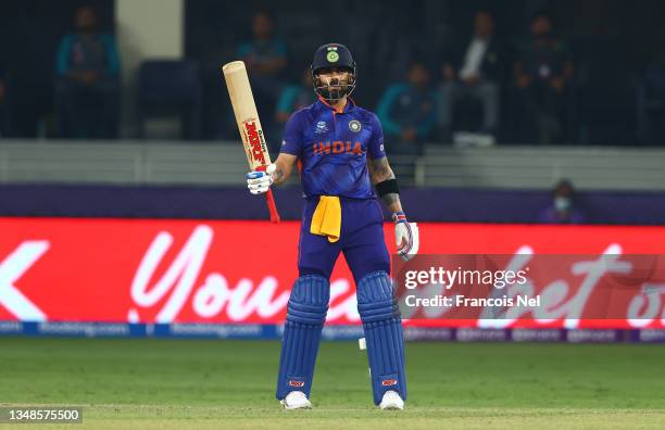 Virat Kohli of India celebrates their half century during the ICC Men's T20 World Cup match between India and Pakistan at Dubai International Stadium...