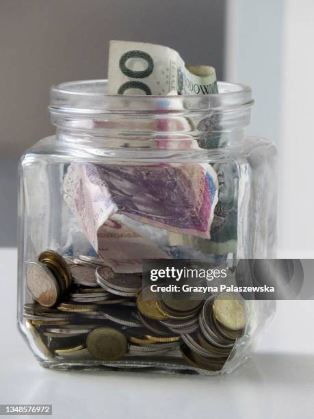 polish money, savings in a jar on the table - zloty stock-fotos und bilder