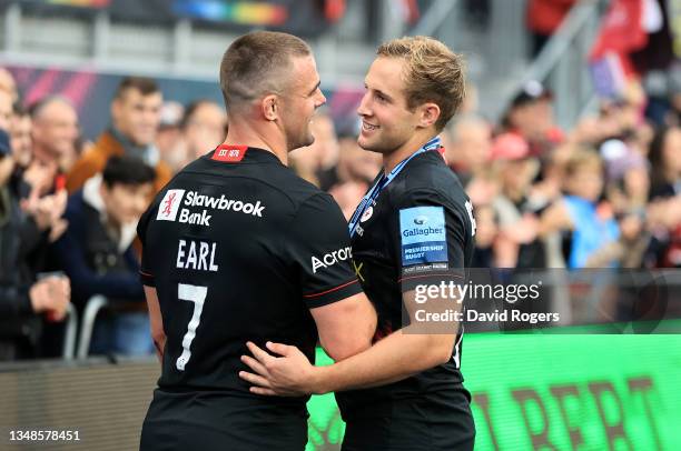 Max Malins of Saracens who scored four tries celebrates with team mate Ben Earl after their victory during the Gallagher Premiership Rugby match...