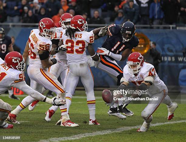 Jon McGraw of the Kansas City Chiefs intercepts a pass intended for Roy Williams of the Chicago Bears that was batted around by teammates including...