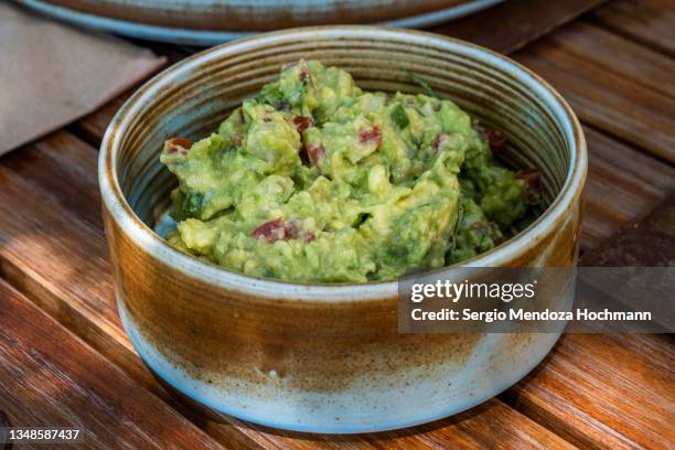 a bowl of delicious guacamole, avocado, for a mexican breakfast - tepoztlan, mexico - guacamole stock-fotos und bilder