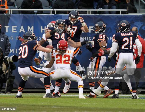 Dexter McCluster of the Kansas City Chiefs moves to catch the ball on a "Hail Mary" pass that was batted by Brian Urlacher and Chris Conte of the...