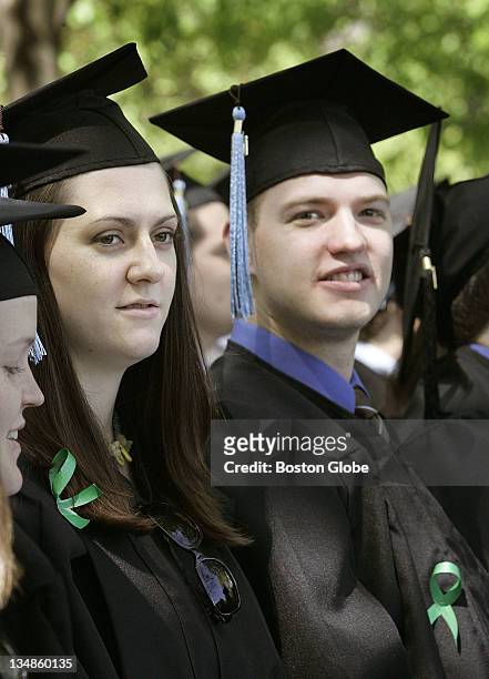 Seth Lancaster, right, of West Virginia, and Joanna Troy, left, of Wellesley, wore green ribbons at Tufts University commencement exercises to show...