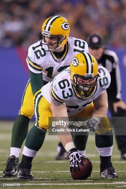 Aaron Rodgers of the Green Bay Packers calls signals out as he stands at the line of scrimmage behind center Scott Wells of the Green Bay Packers...