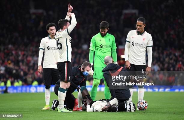 Naby Keita of Liverpool receives medical treatment following a challenge by Paul Pogba of Manchester United before being stretchered off during the...