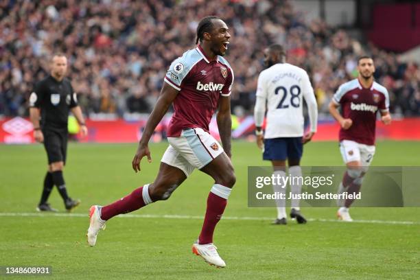 Michail Antonio of West Ham United celebrates after scoring their side's first goal with team mates during the Premier League match between West Ham...