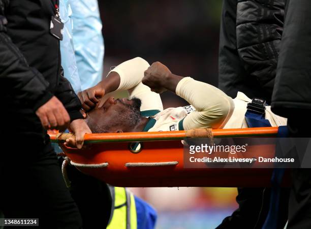 Naby Keita of Liverpool goes off injured after a collision with Paul Pogba of Manchester United during the Premier League match between Manchester...