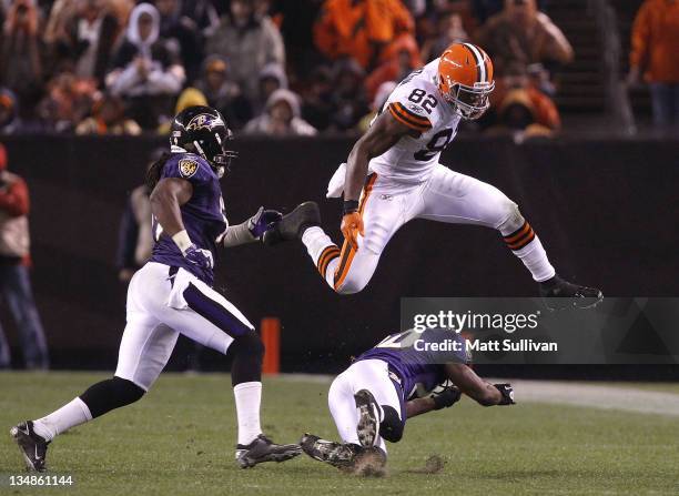 Tight end Benjamin Watson of the Cleveland Browns jumps over safety Ed Reed of the Baltimore Ravens before being hit by linebacker Dannell Ellerbe at...