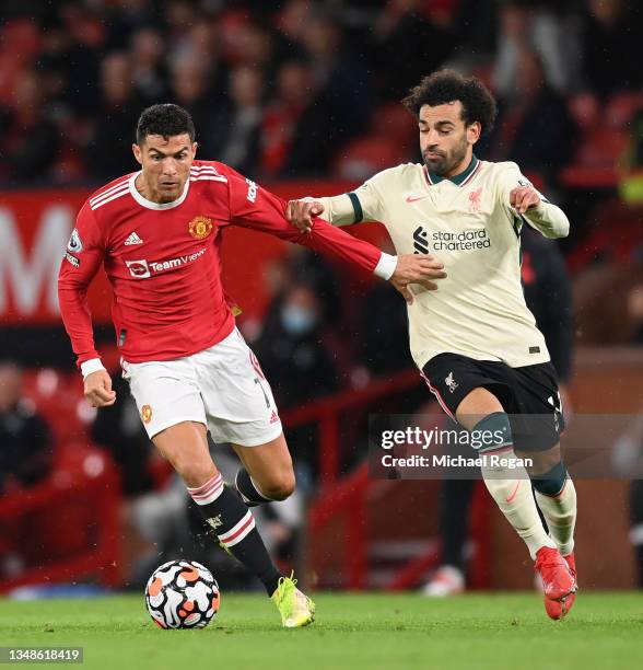 Cristiano Ronaldo of Manchester United holds off Mohamed Salah of Liverpool during the Premier League match between Manchester United and Liverpool...