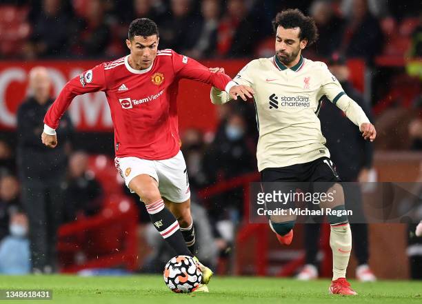 Cristiano Ronaldo of Manchester United holds off Mohamed Salah of Liverpool during the Premier League match between Manchester United and Liverpool...