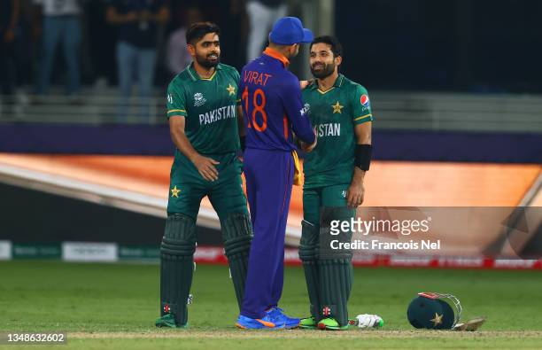 Mohammad Rizwan and Babar Azam of Pakistan interact with Virat Kohli of India following the ICC Men's T20 World Cup match between India and Pakistan...