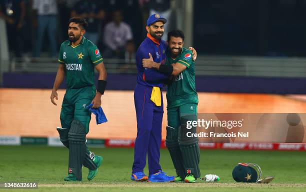 Mohammad Rizwan and Babar Azam of Pakistan interact with Virat Kohli of India following the ICC Men's T20 World Cup match between India and Pakistan...